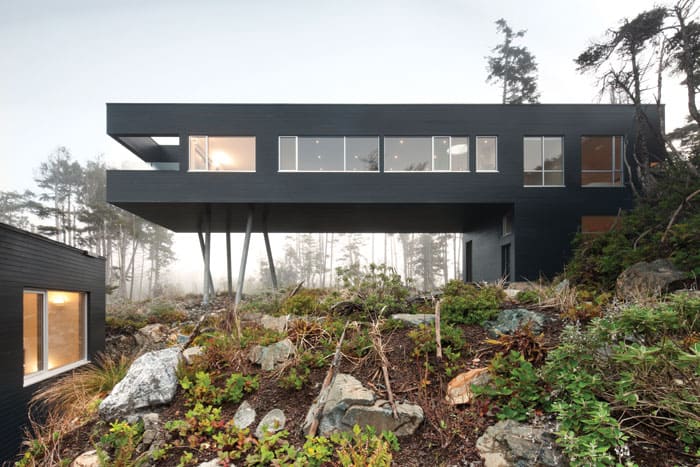 This Tofino residence is designed with environmental efficiencies: the flooring is recycled arbutus from blow-downs, the green roof is planted with moss, and it was built in a prefab factory and trucked in. 