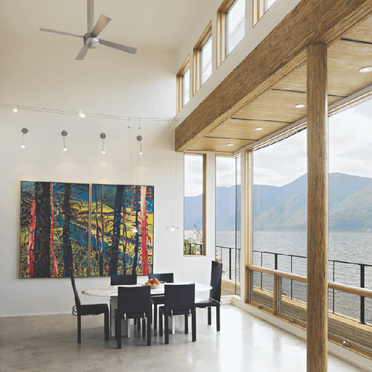 DINING ROOM At the west-facing wall of windows, the lowered ceiling (supported by a column of laminated aspen) helps to deflect the summer sun’s rays.