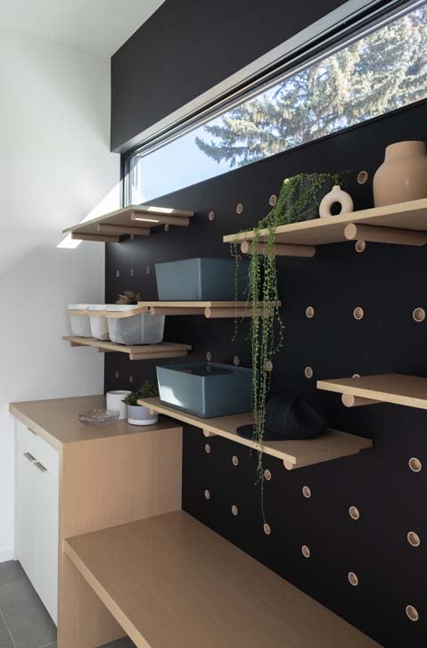 Boot storage, bench and durable tile flooring in the Affogato mud room by Nako Design
