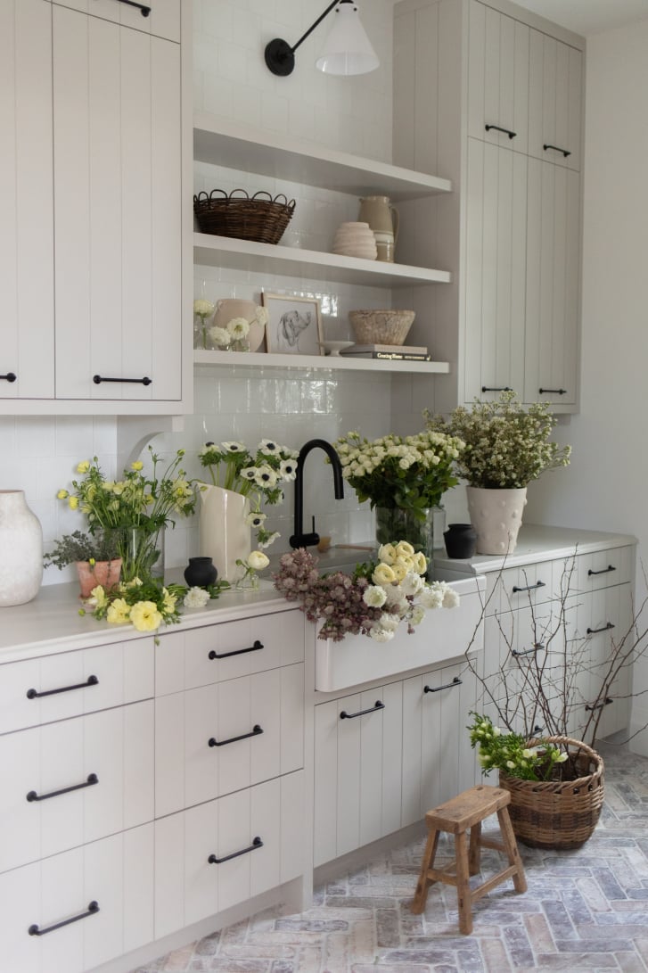 Fort Langley mudroom by Rose and Funk with apron-front sink, shiplap cabinetry and brick flooring