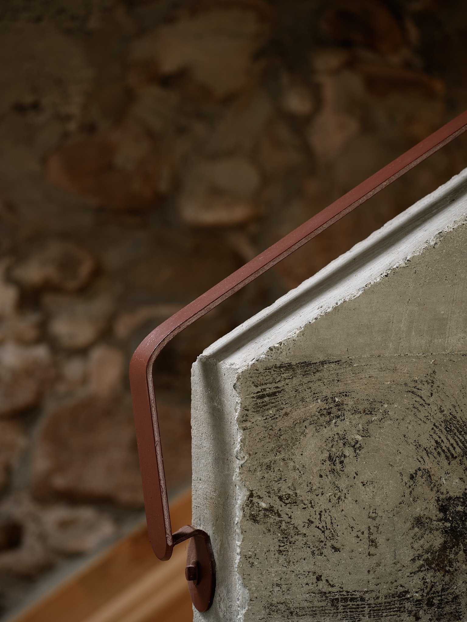 Concrete-and-stone foyer with courtyard doors at The Barn, designed by &Daughters