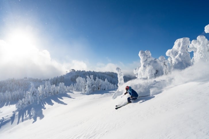 A quiet ski run with snow-covered trees at Sun Peaks Resort
