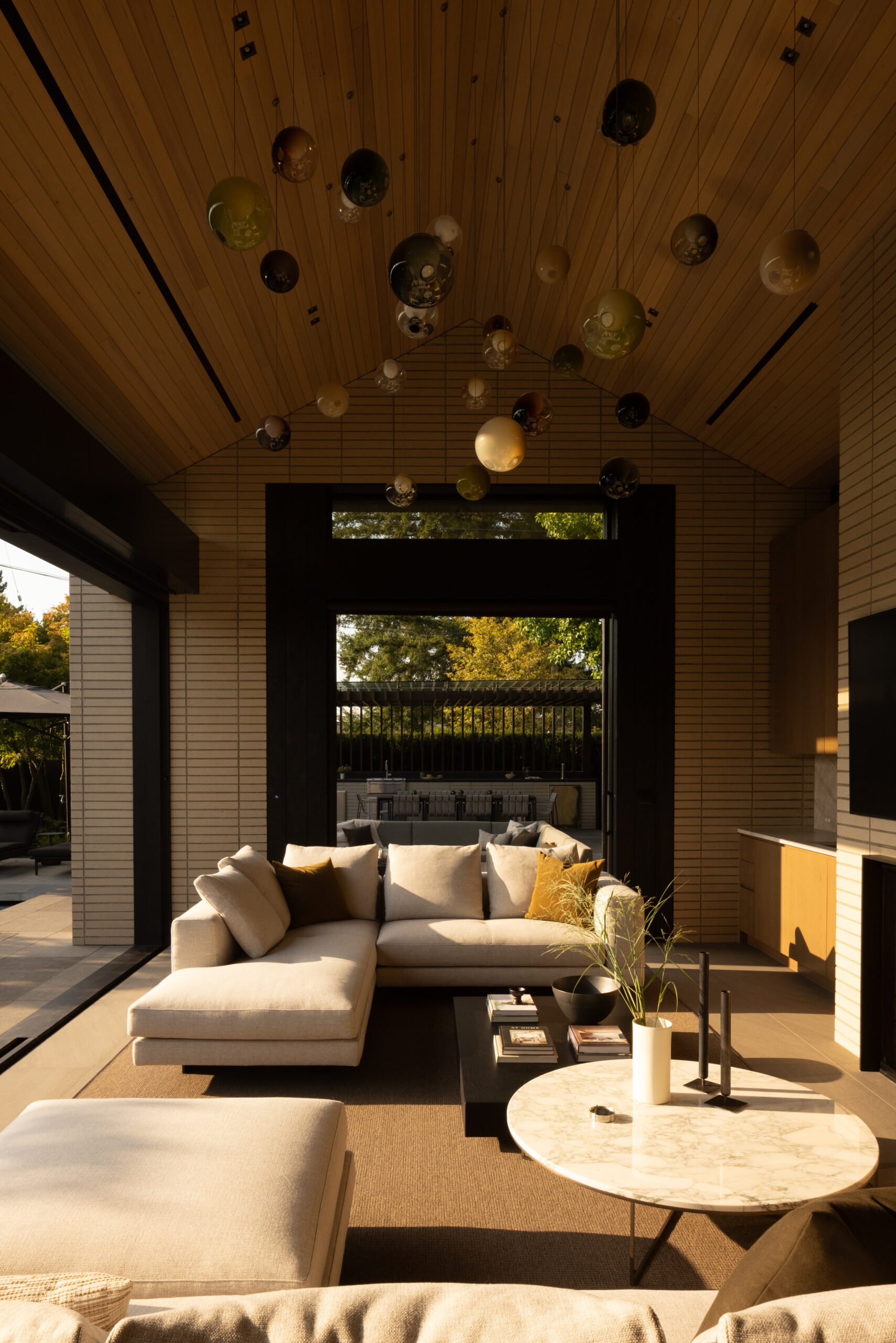 Brick and warm natural materials in the Brick House great room by HB Design