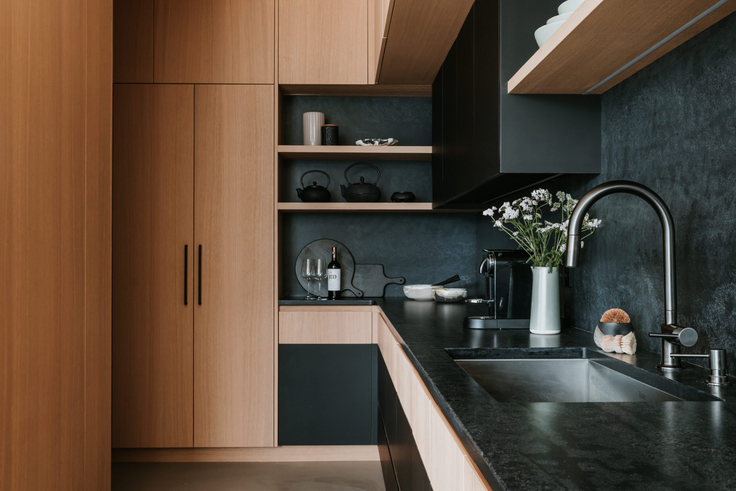 Textured stone and tailored millwork in the Sunstone kitchen by LRD Studio