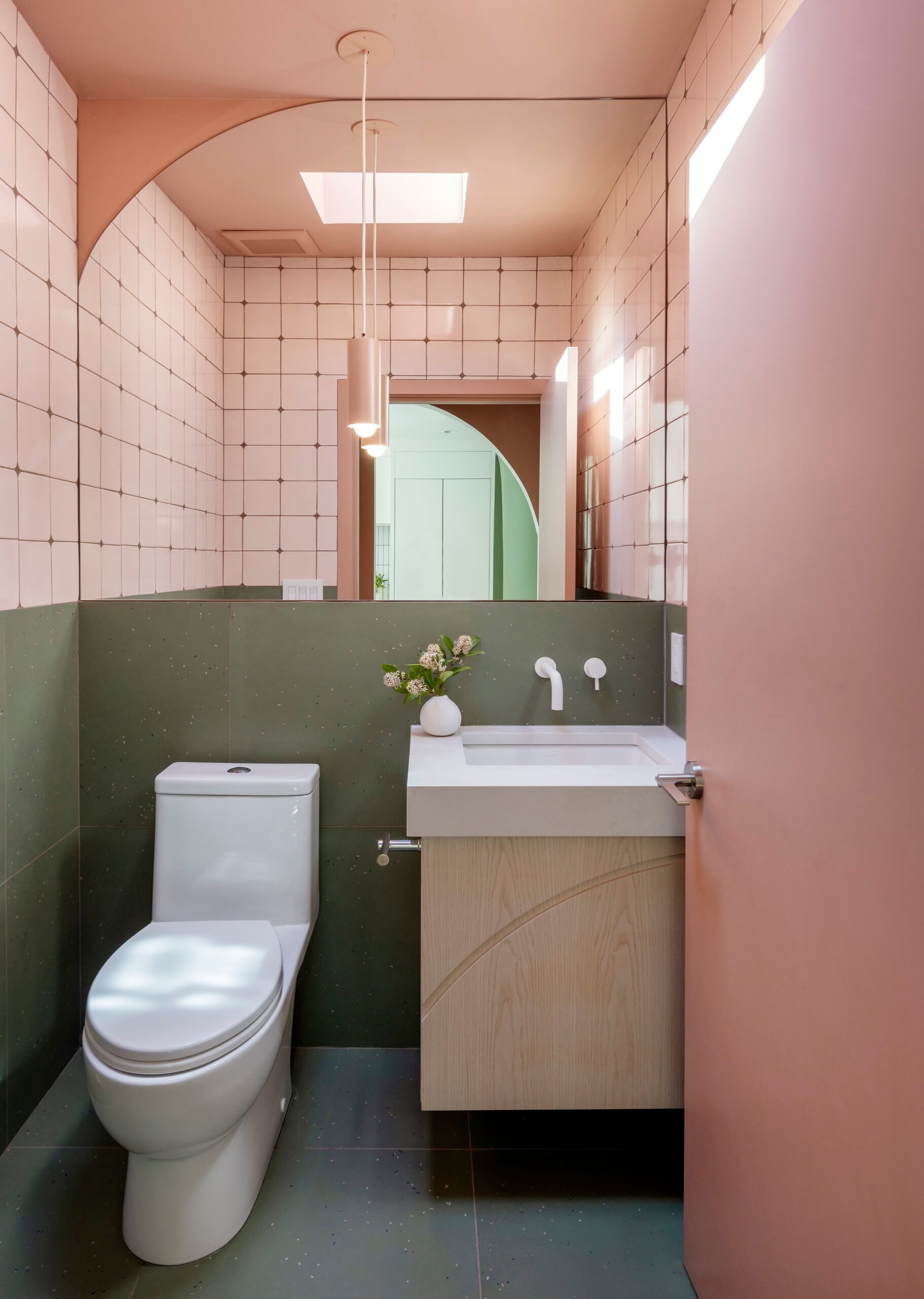 Dusty-rose vestibule and asymmetrical arch at the Little Mountain powder room, Vancouver