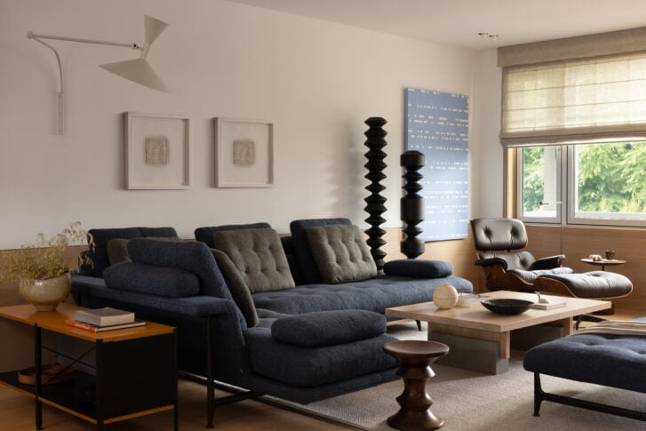 Living room with warm oak wainscoting and art collection in Kitsilano Craftsman renovation
