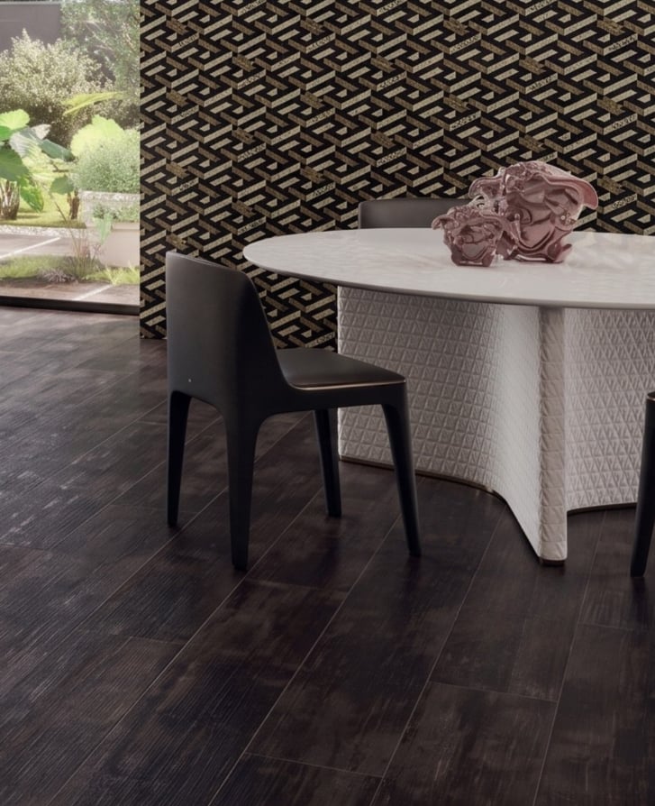 Dining room with dark wood-look Versace Eterno Carbon porcelain floor tiles