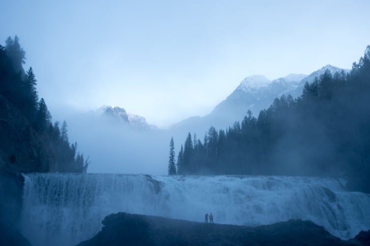 Winter hikers exploring the snow-covered Wapta Falls trail in Yoho National Park near Golden, British Columbia