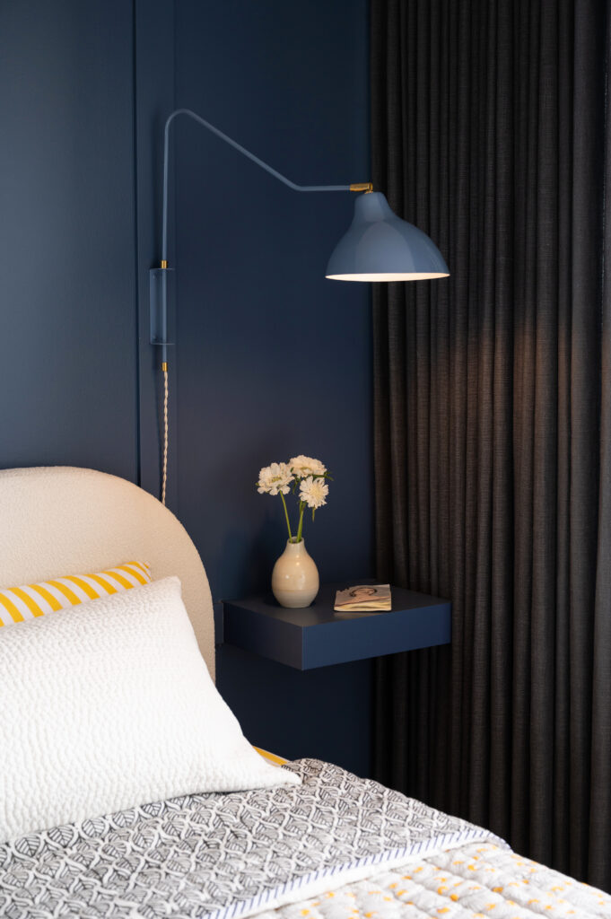 close-up view of blue bedside table and reading lamp