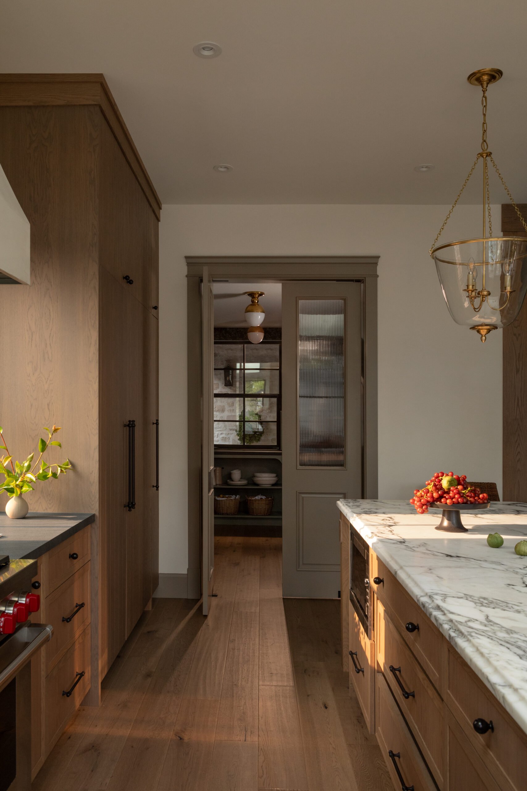 Leathered stone surfaces and layered storage in the Timeless pantry by Jessica Bremner Design