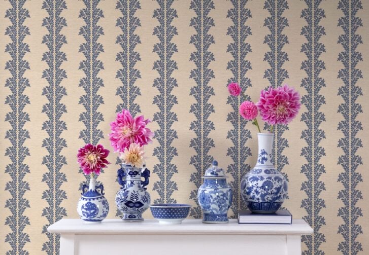 Odette wallpaper by Kelly Deck in blue and cream, styled with vases and flowers