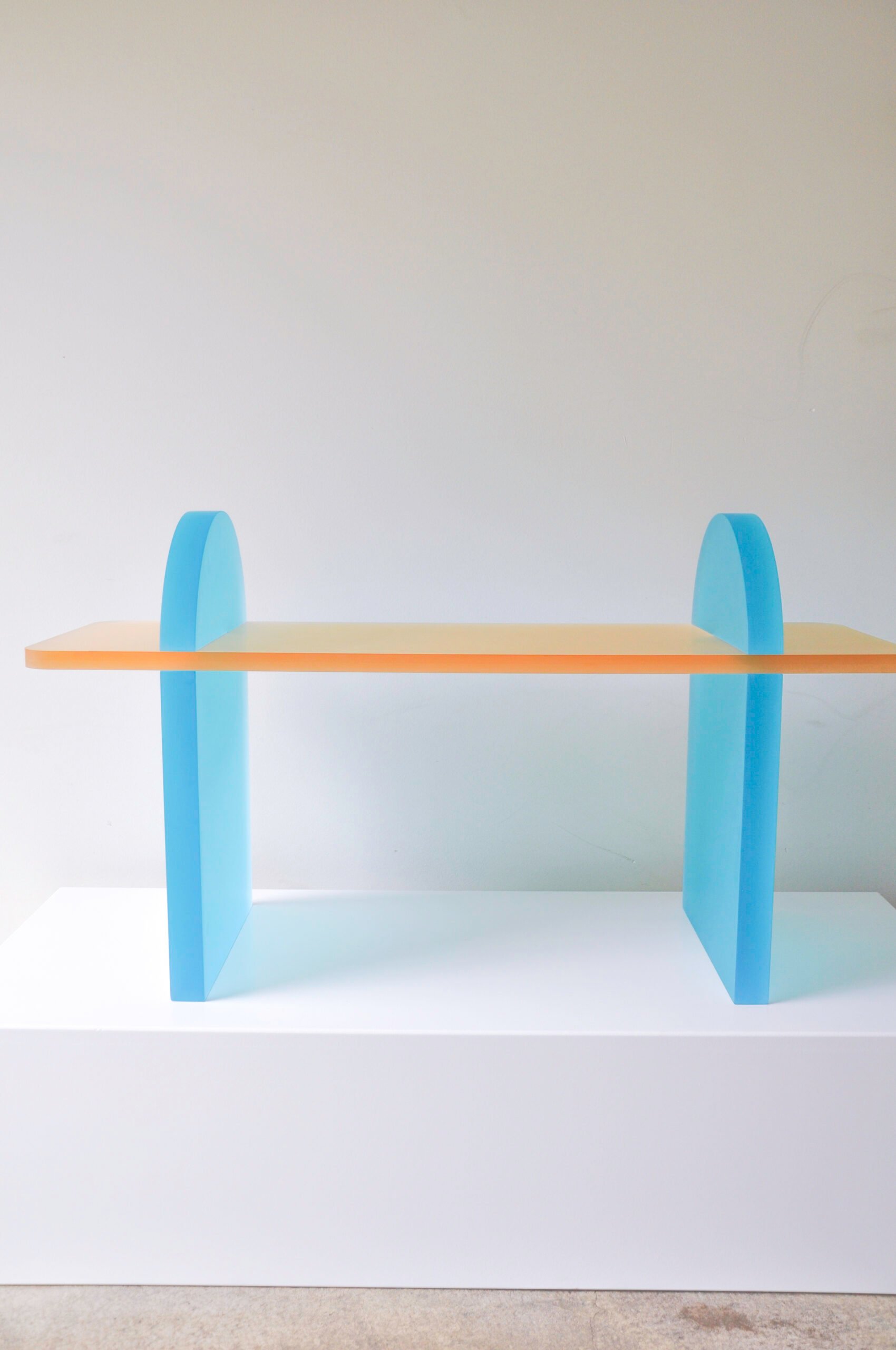 Rounded blue arches and translucent orange top on the Crhaze coffee table by Lakaz Studio