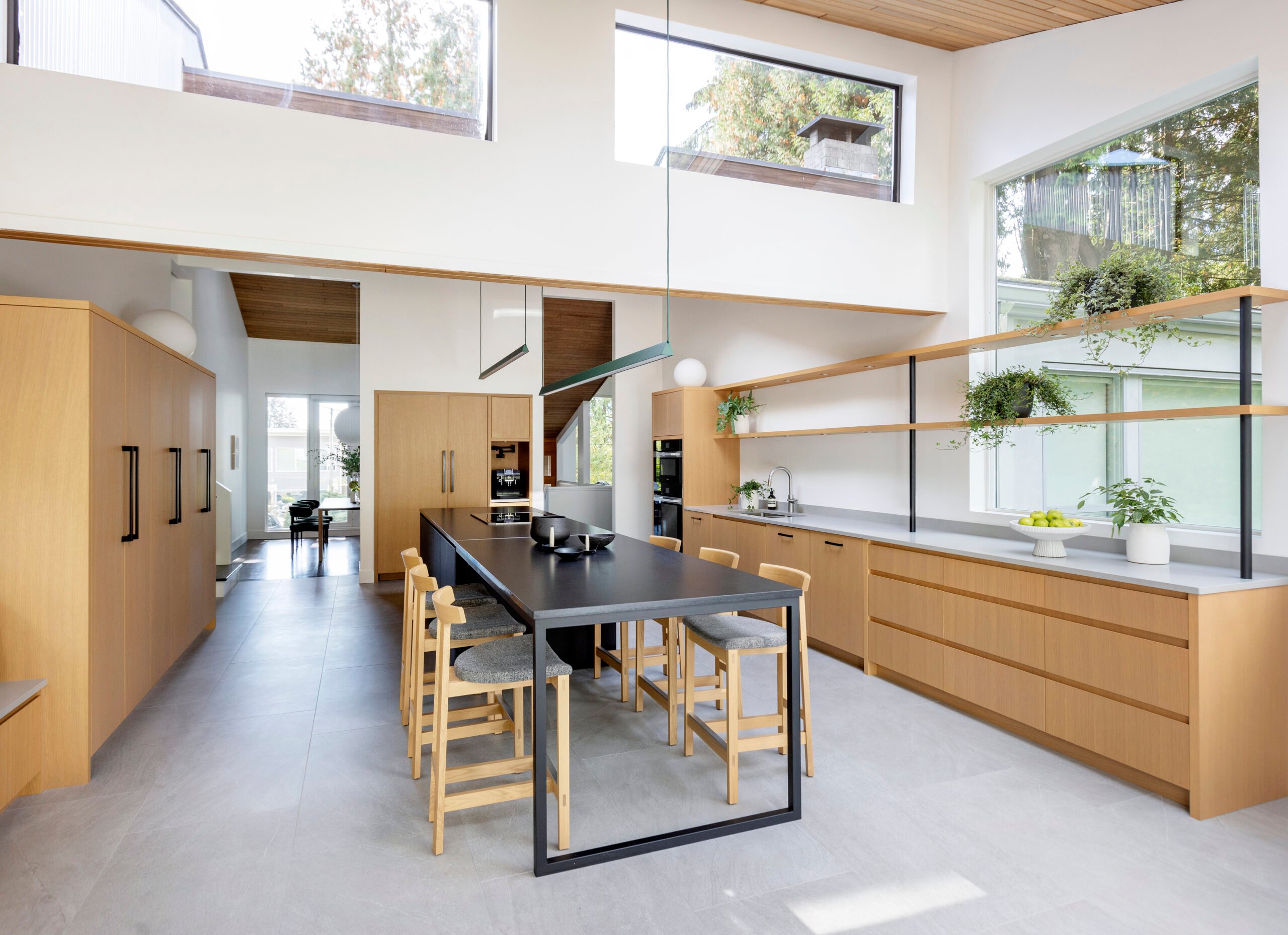 Rift-cut oak cabinetry and open shelving in the North Vancouver kitchen by Peter Wilds Design