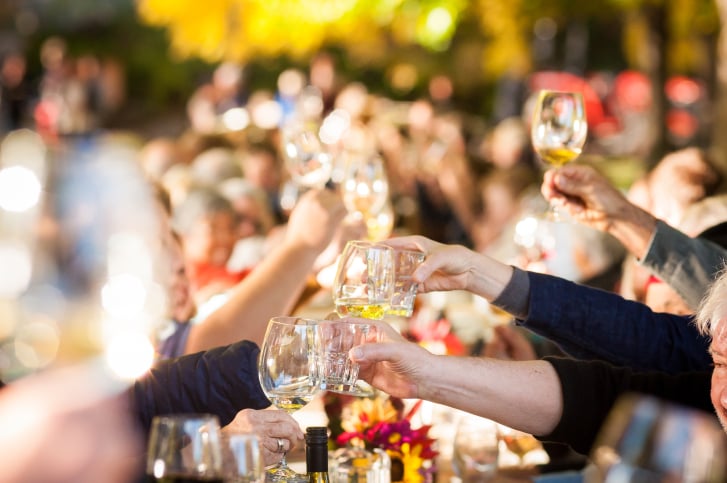 Naramata Slow Long Table Dinner with diners seated outdoors at a communal table