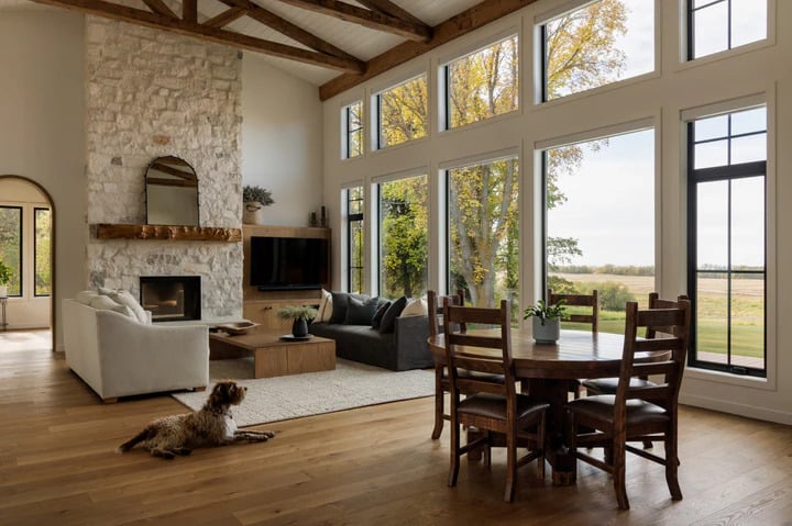 Living room with warm North American white oak flooring, a fireplace and a dog on the floor