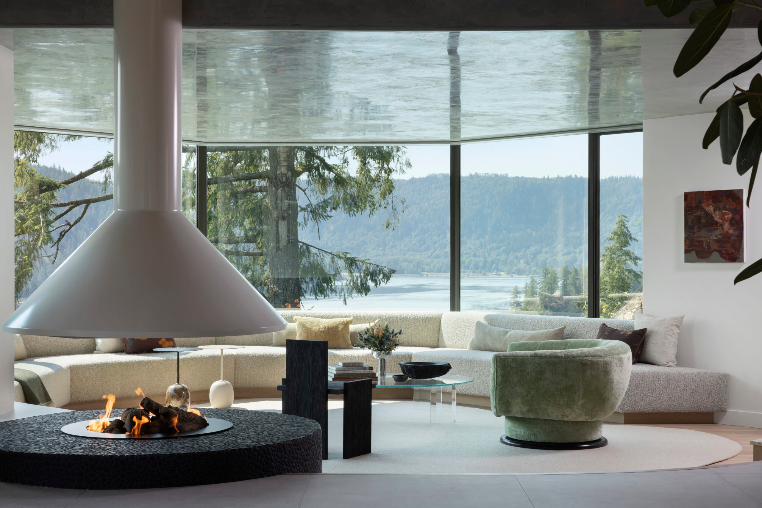 Curved seating and panoramic windows in the Deep Cove living room, North Vancouver