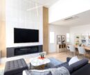 Interior living room with light rod lighting fixture and hardwood floors with white walls, minimalist design