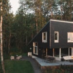 angular cabin exterior with fibre cement siding, acrylic stucco and an outdoor terrace