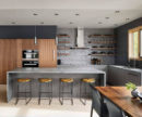 A modern design kitchen with grey walls and wood table