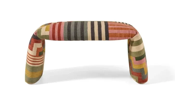 Nanimarquina multicoloured pouf shaped like a folded rug on white background