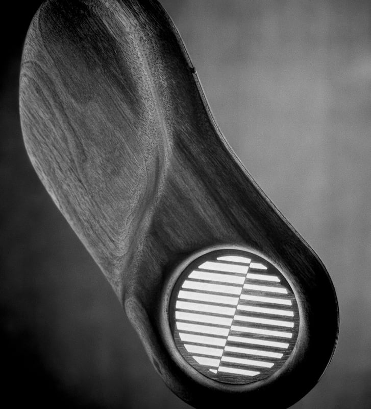 Bent walnut and brass screen detail on the Samara chandelier