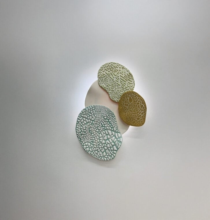 Textured ceramic panels on the Eclipse sconce by Meg Hübert Ceramics